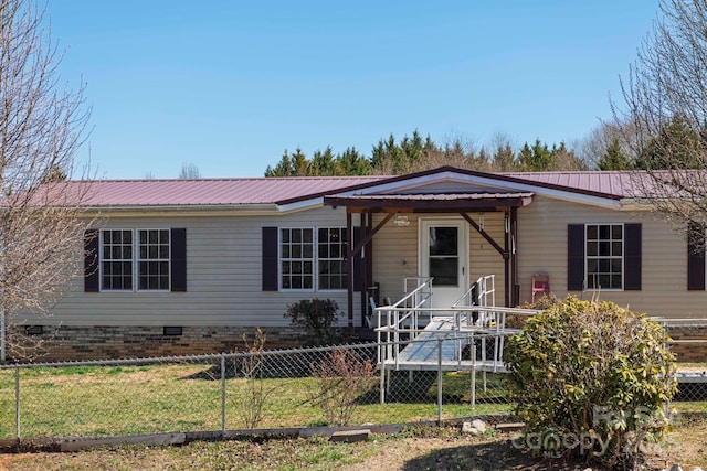 manufactured / mobile home featuring a front lawn, fence private yard, metal roof, and crawl space