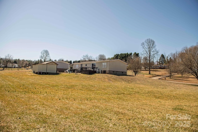 view of yard with an outdoor structure and a rural view