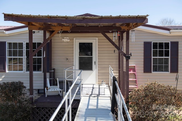 property entrance featuring metal roof and a pergola