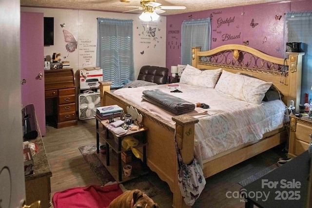 bedroom featuring a ceiling fan and wood finished floors