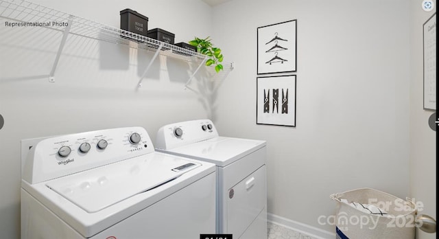 laundry area featuring laundry area, washing machine and dryer, and baseboards