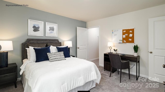 bedroom featuring light carpet and baseboards