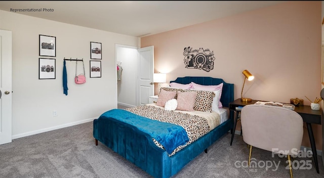 bedroom featuring carpet and baseboards