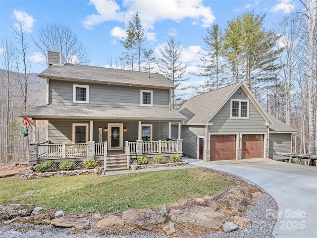 view of front of house with a front lawn, driveway, covered porch, a garage, and a chimney