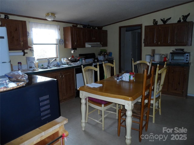 kitchen featuring extractor fan, a toaster, electric range oven, ornamental molding, and a sink