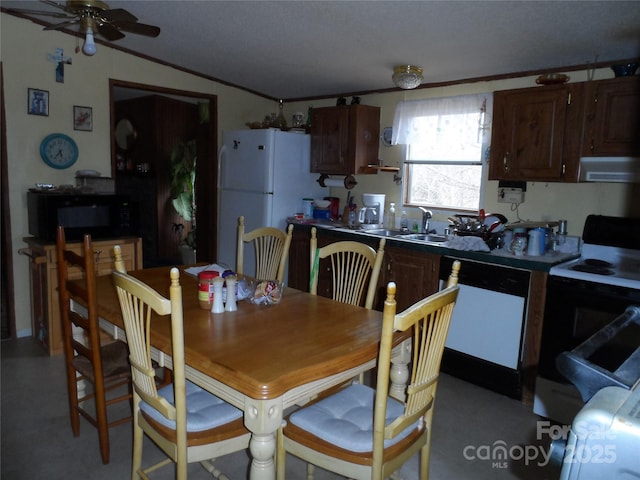 dining space featuring lofted ceiling, ceiling fan, and crown molding