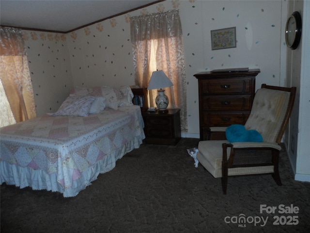 bedroom with crown molding and carpet floors