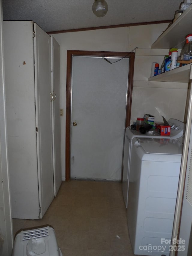 laundry area with laundry area, washing machine and dryer, and light floors