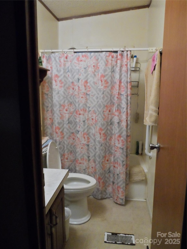 full bathroom with tile patterned floors, a shower with shower curtain, toilet, and vanity