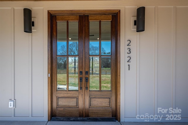 doorway to property featuring french doors and board and batten siding