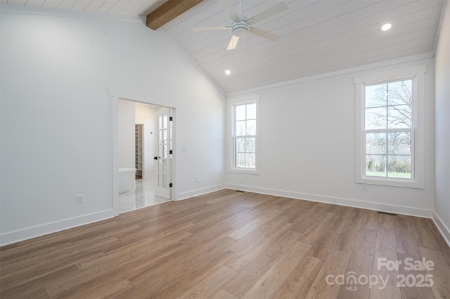 unfurnished room with beam ceiling, baseboards, ceiling fan, and wood finished floors
