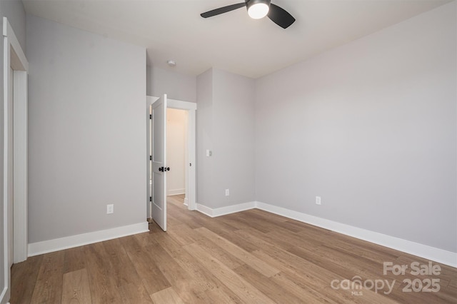 unfurnished bedroom with a ceiling fan, light wood-style floors, and baseboards