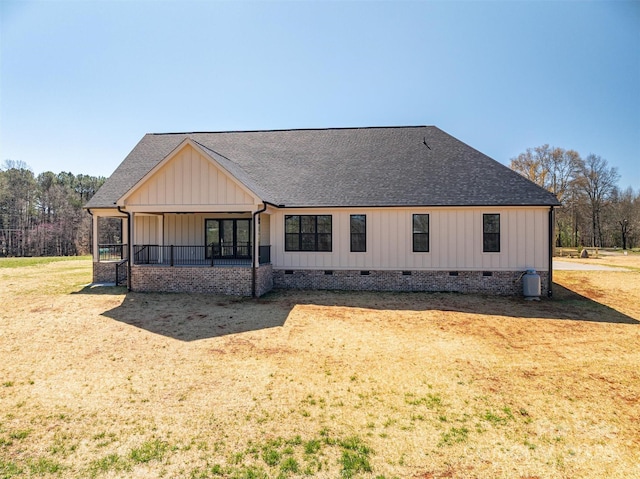 rear view of property with crawl space, covered porch, board and batten siding, and a shingled roof