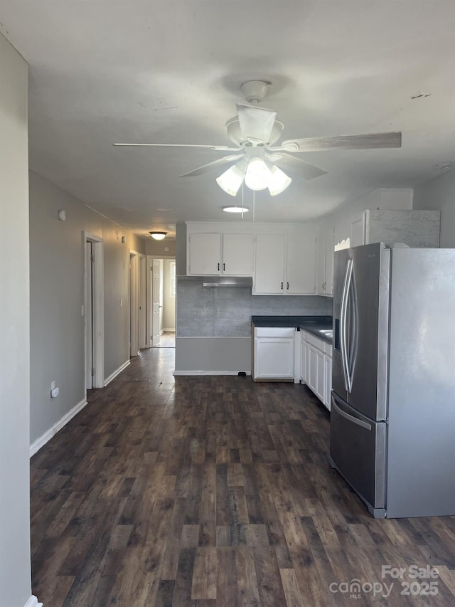 kitchen with dark wood-style flooring, white cabinets, ceiling fan, and stainless steel fridge with ice dispenser