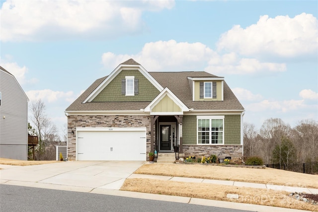 craftsman-style house with stone siding, concrete driveway, a garage, and a shingled roof