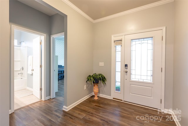 foyer entrance with dark wood-style floors, baseboards, and ornamental molding