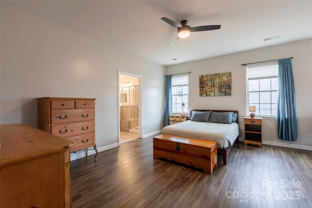 bedroom featuring visible vents, baseboards, dark wood-style floors, and ensuite bathroom