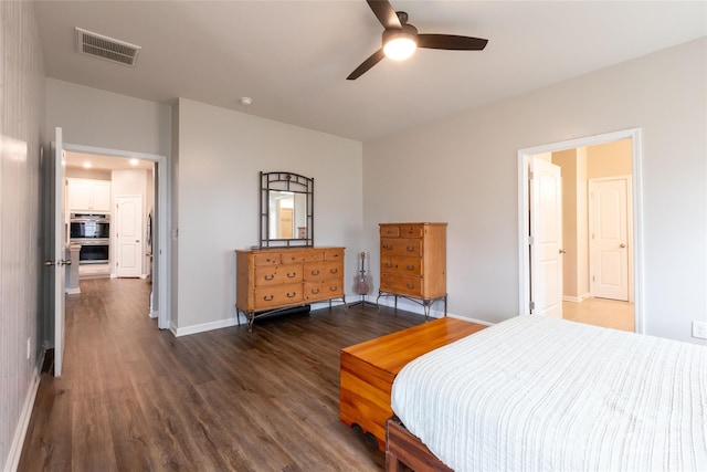 bedroom featuring visible vents, baseboards, dark wood finished floors, and a ceiling fan