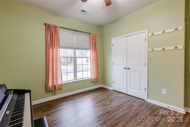 interior space with baseboards and wood finished floors