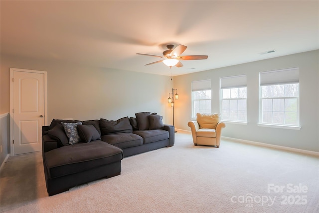 carpeted living room with a ceiling fan, visible vents, and baseboards