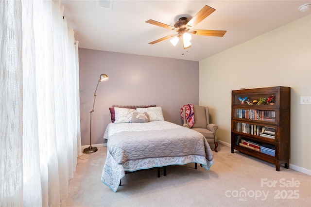 bedroom with ceiling fan, baseboards, and carpet floors