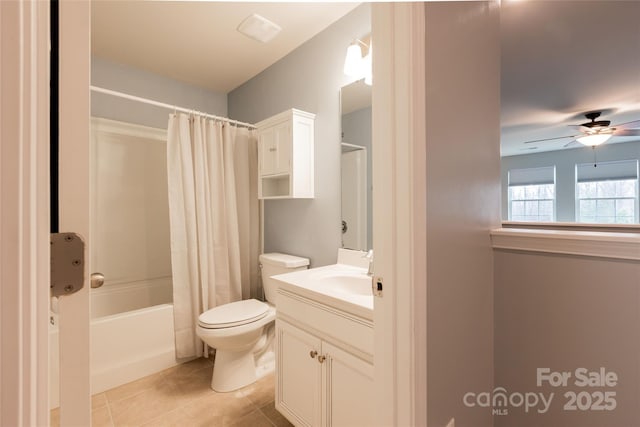 full bathroom with vanity, a ceiling fan, tile patterned flooring, shower / tub combo, and toilet