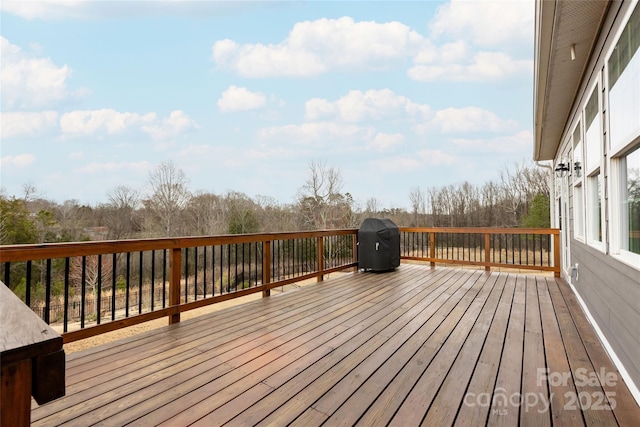 wooden terrace featuring a grill