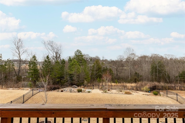 view of yard with fence and a view of trees