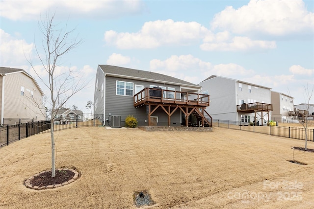 back of property featuring a wooden deck, a fenced backyard, stairs, and a gate