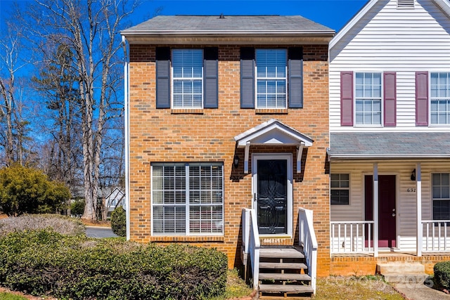 townhome / multi-family property featuring brick siding