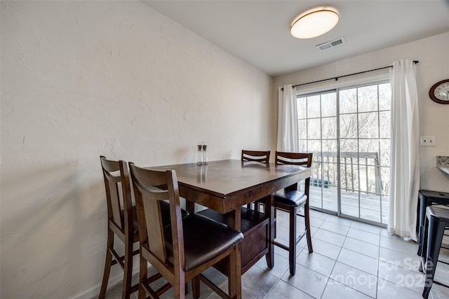 dining area with light tile patterned flooring and visible vents