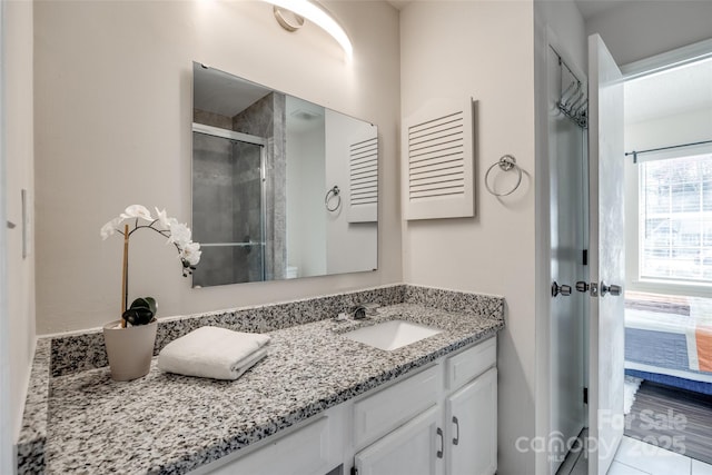 bathroom featuring a stall shower, vanity, and ensuite bathroom