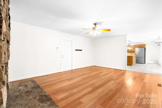 1080 Rolling Green Dr, Newton, NC 28658 - unfurnished living room with ceiling fan, light wood-style floors, crown molding, and baseboards