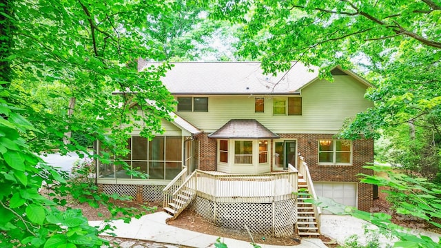 1080 Rolling Green Dr, Newton, NC 28658 - back of property featuring stairs, a sunroom, brick siding, and a garage