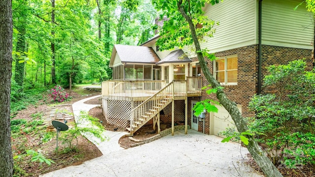 1080 Rolling Green Dr, Newton, NC 28658 - back of property with a sunroom, stairs, brick siding, driveway, and a garage