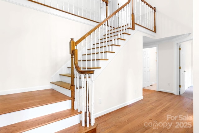1080 Rolling Green Dr, Newton, NC 28658 - stairway with wood finished floors, baseboards, and a towering ceiling
