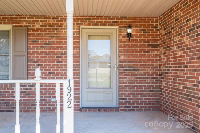 entrance to property with brick siding