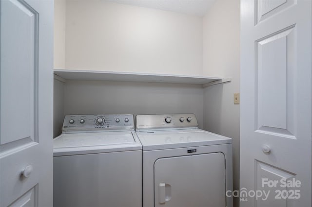 laundry room with washer and dryer and laundry area