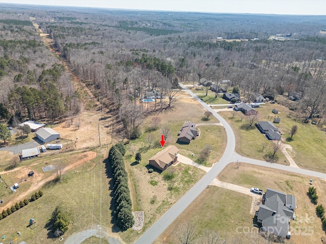 bird's eye view featuring a rural view and a wooded view