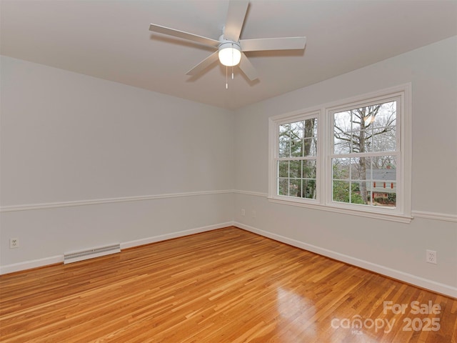 unfurnished room featuring visible vents, baseboards, light wood-style floors, and ceiling fan