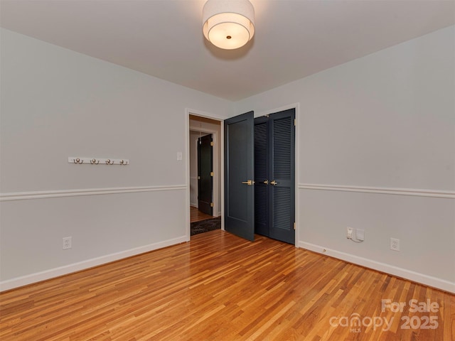 empty room featuring baseboards and wood finished floors