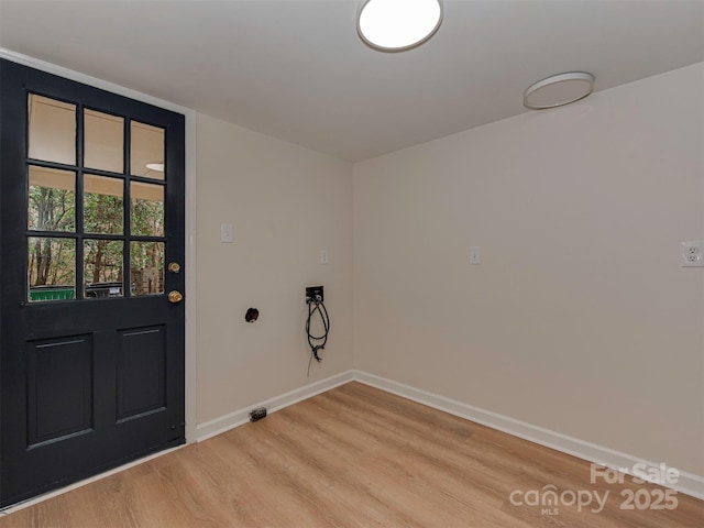 washroom with light wood-type flooring, baseboards, hookup for a washing machine, and laundry area