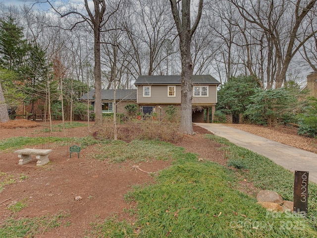 view of front of property featuring a carport and concrete driveway