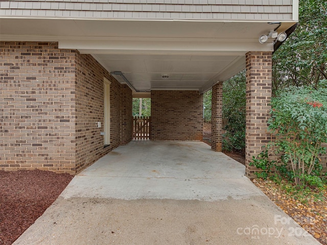 view of patio featuring an attached carport and concrete driveway