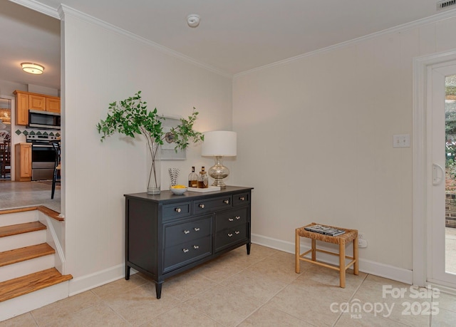 interior space with light tile patterned flooring, crown molding, and baseboards