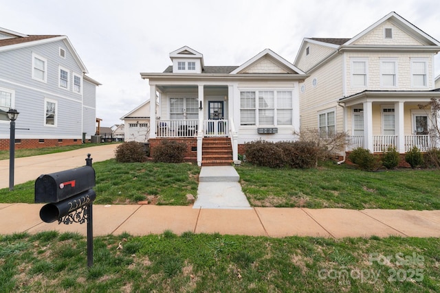 view of front of house with a garage, covered porch, and a front yard