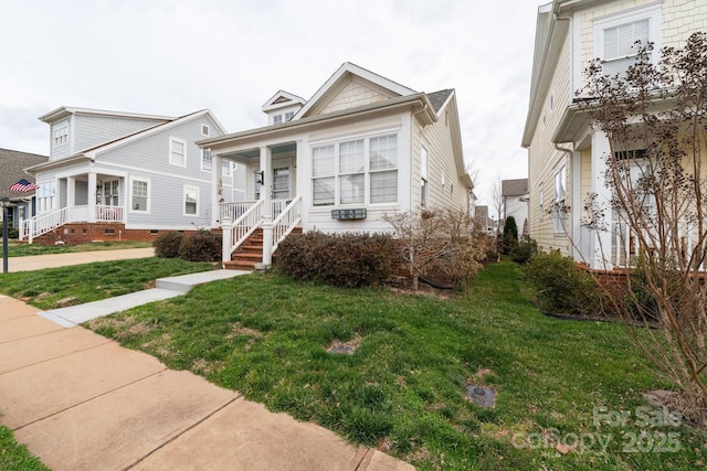 view of front of home featuring covered porch and a front lawn