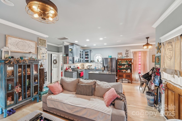 living room featuring visible vents, recessed lighting, light wood-type flooring, and ornamental molding