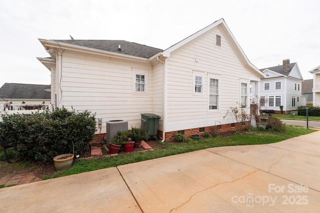 rear view of property with cooling unit and crawl space