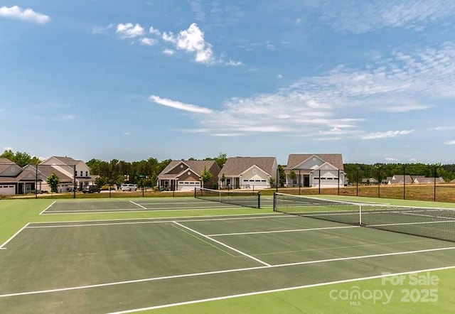 view of sport court with fence and a residential view